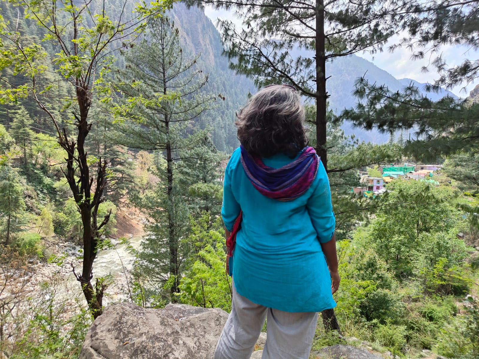 A person looking across a wide mountain valley