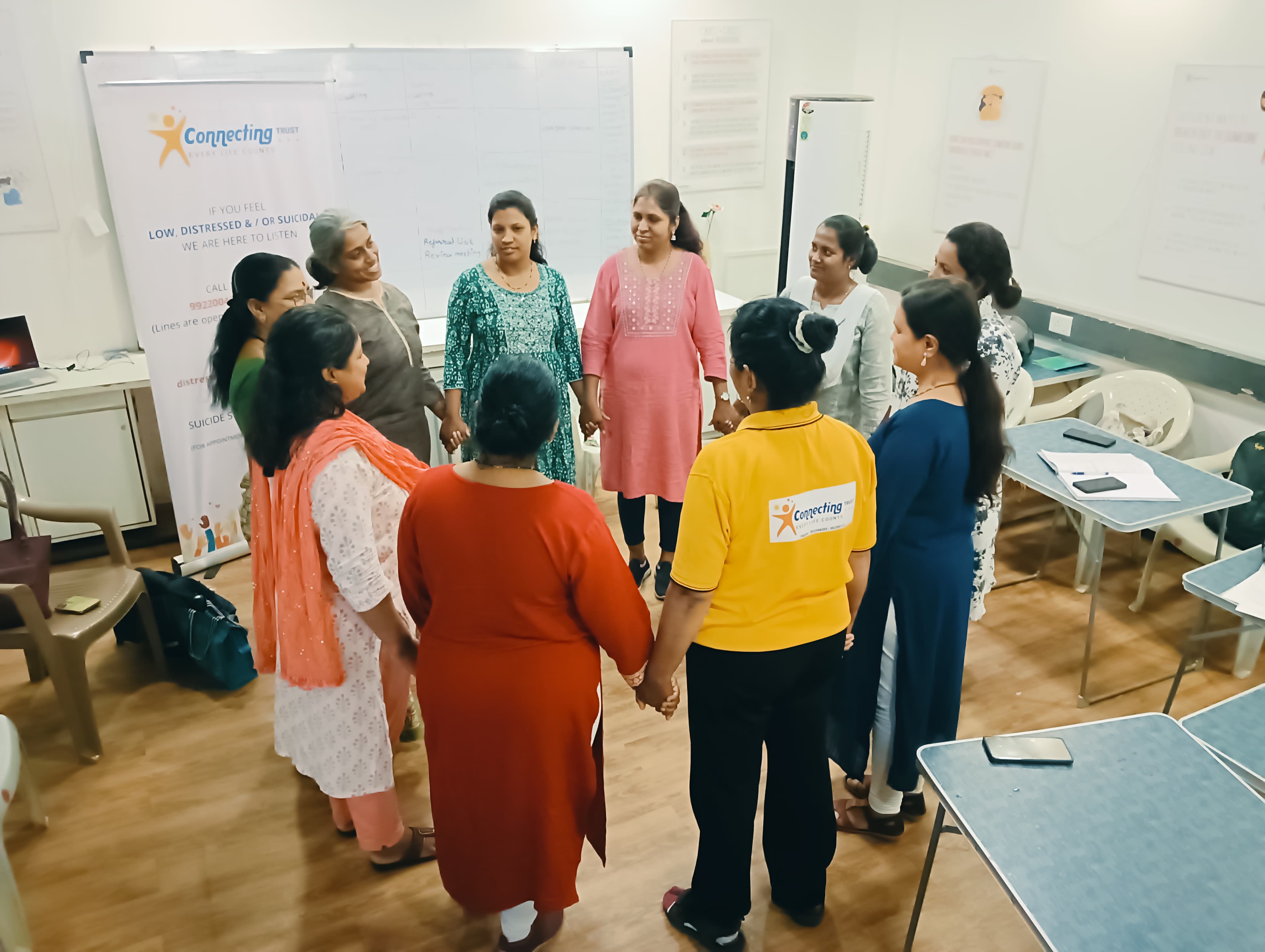 Participants standing together in a facilitated circle